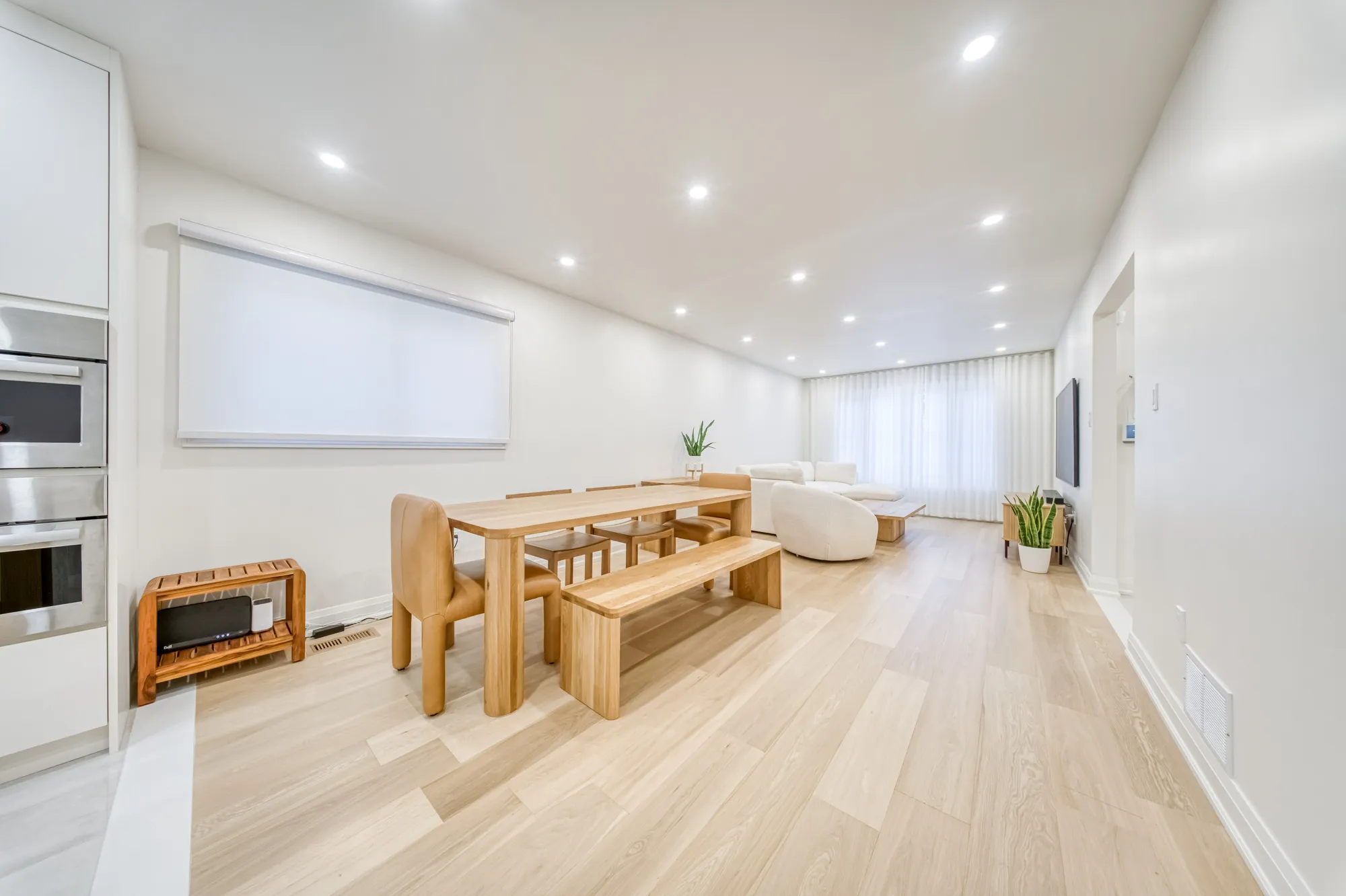 The finished dining room: an oak table and bench, open to the living room.