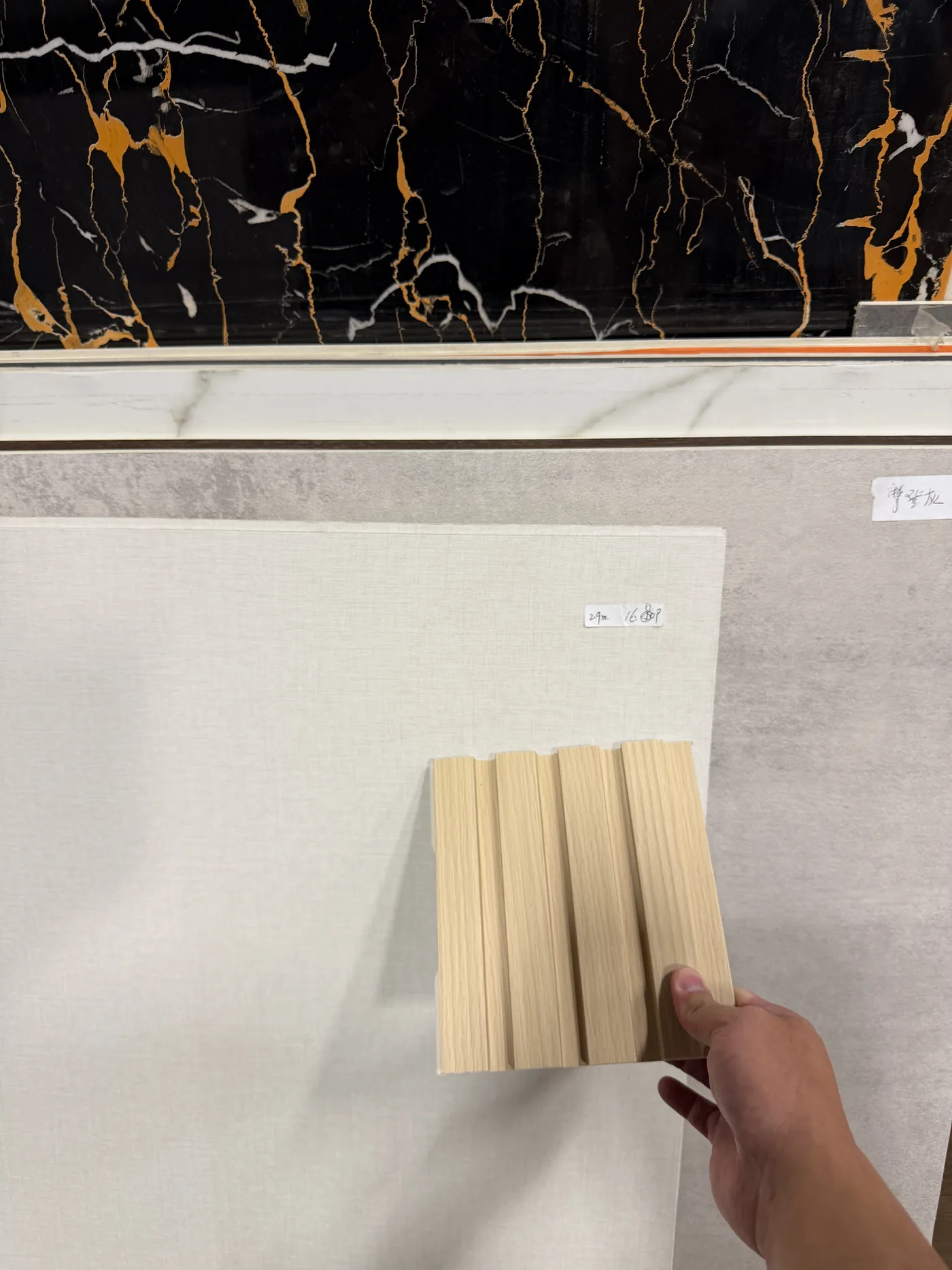 Oak slats against a black and gold marble sample.