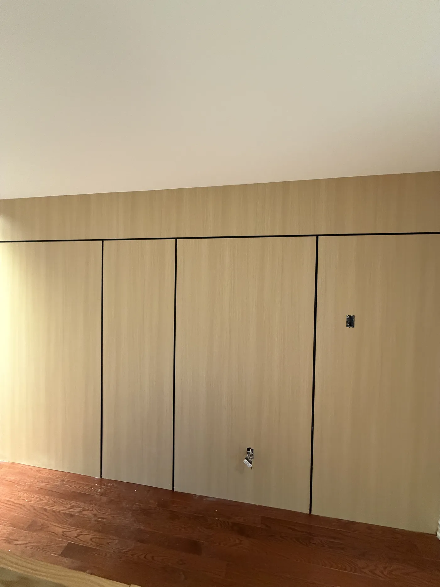 The bedroom mid-build: a wall of oak wardrobes installed.