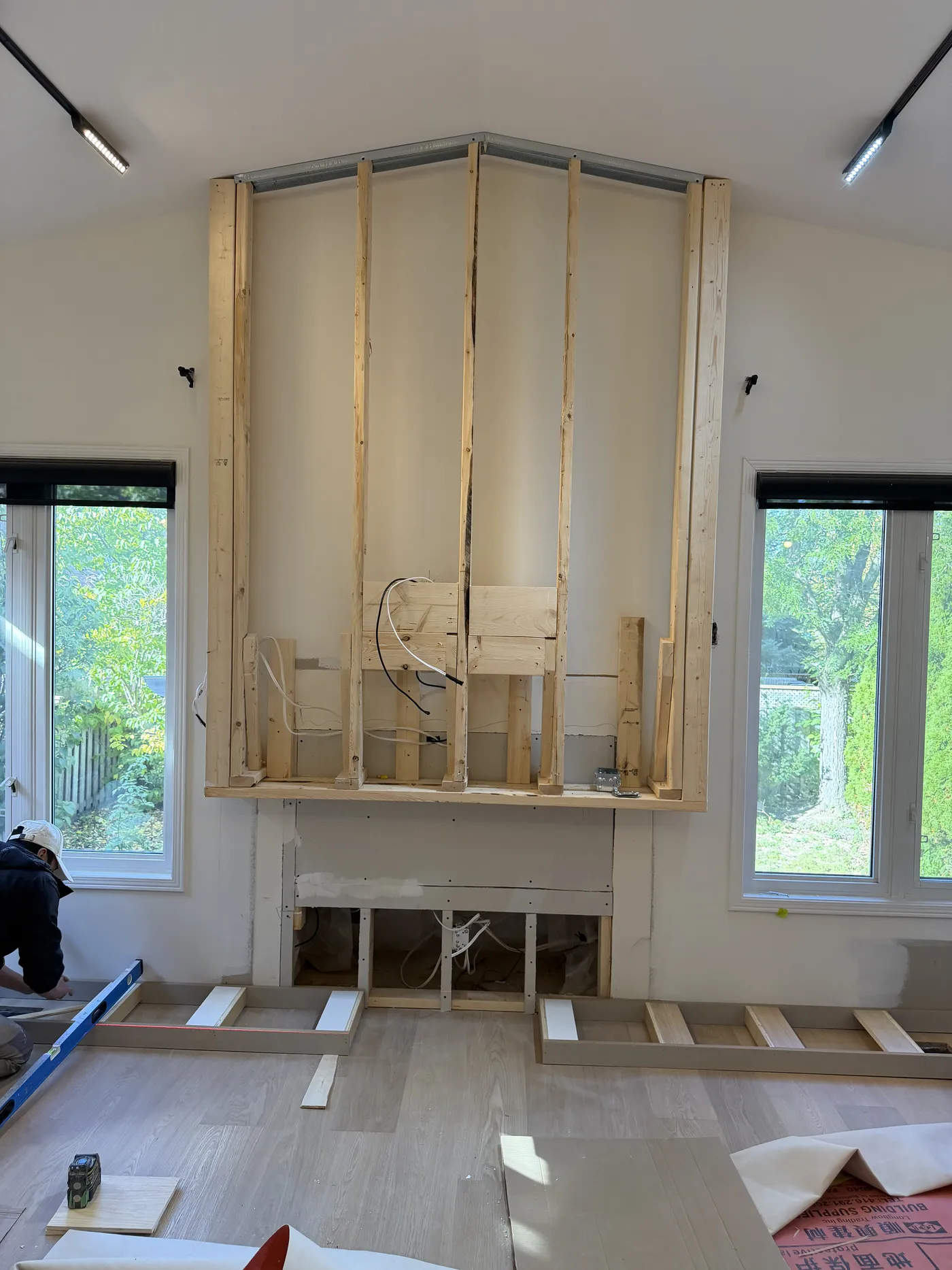 The family room mid-build: a full-height fireplace wall framed in.