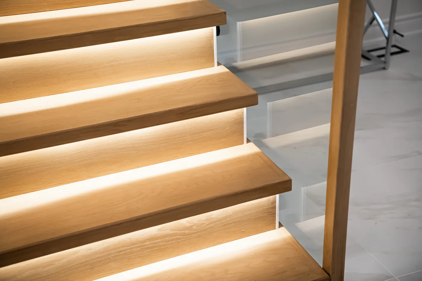 Stair treads lit from beneath, close up.