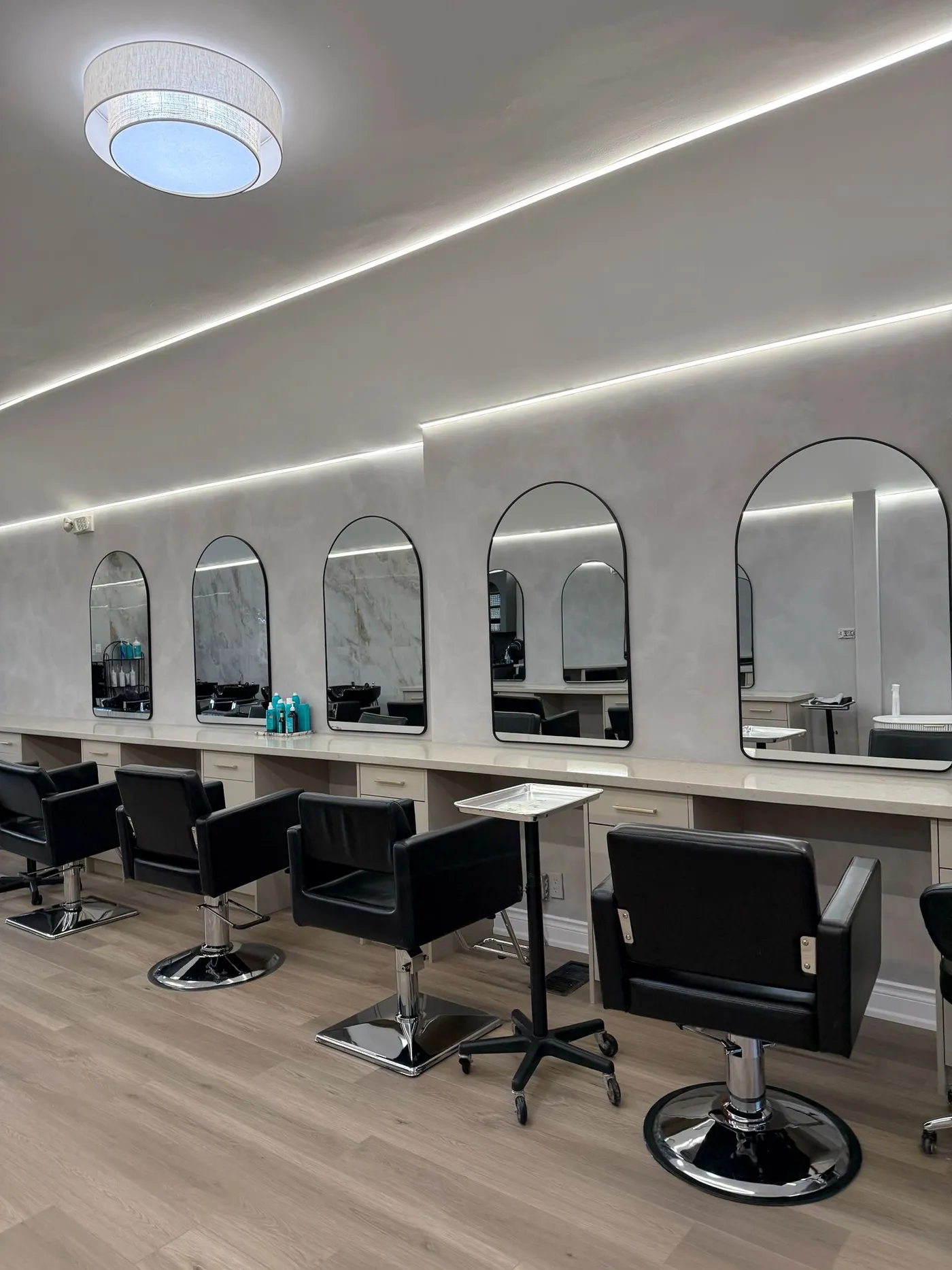 Styling stations under arched mirrors.